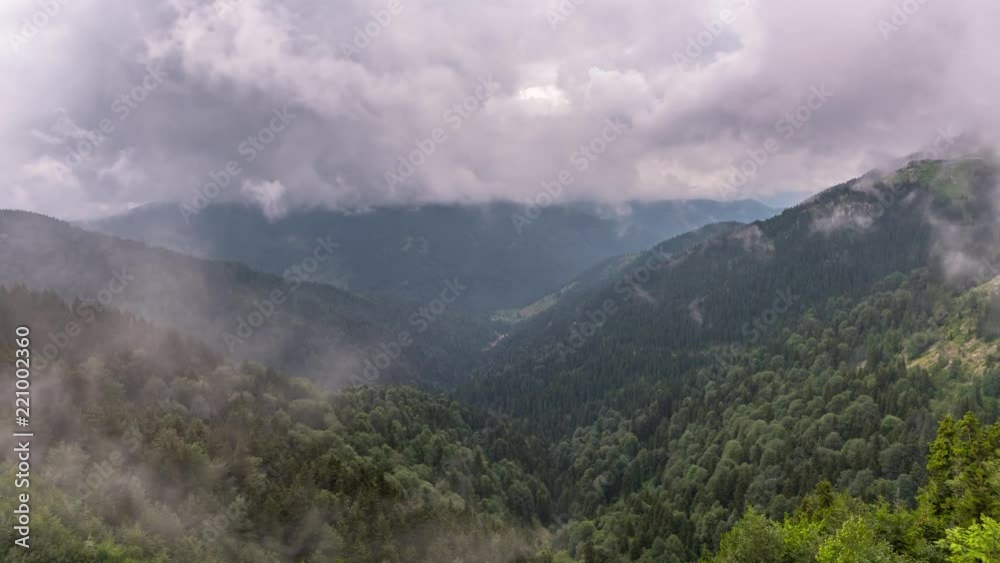 Beautiful waves of low clouds flows over the mountains. time lapse Beautiful waves of low clouds flows over the mountains. time lapse