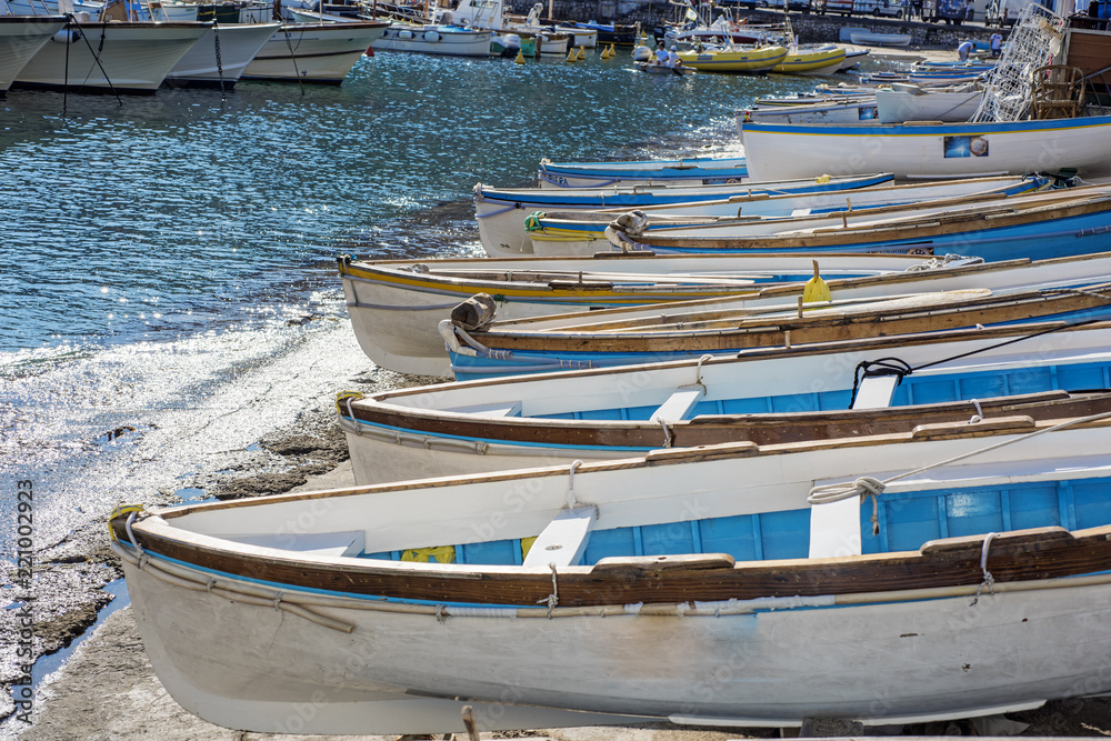 Small wooden boats at city river coats. Sunny day