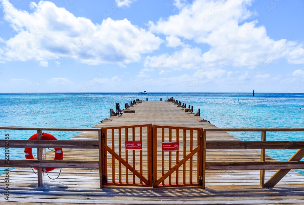 Boardwalk/Pier from a tropical Caribbean beach into the ocean Boardwalk/Pier from a tropical Caribbean beach into the ocean