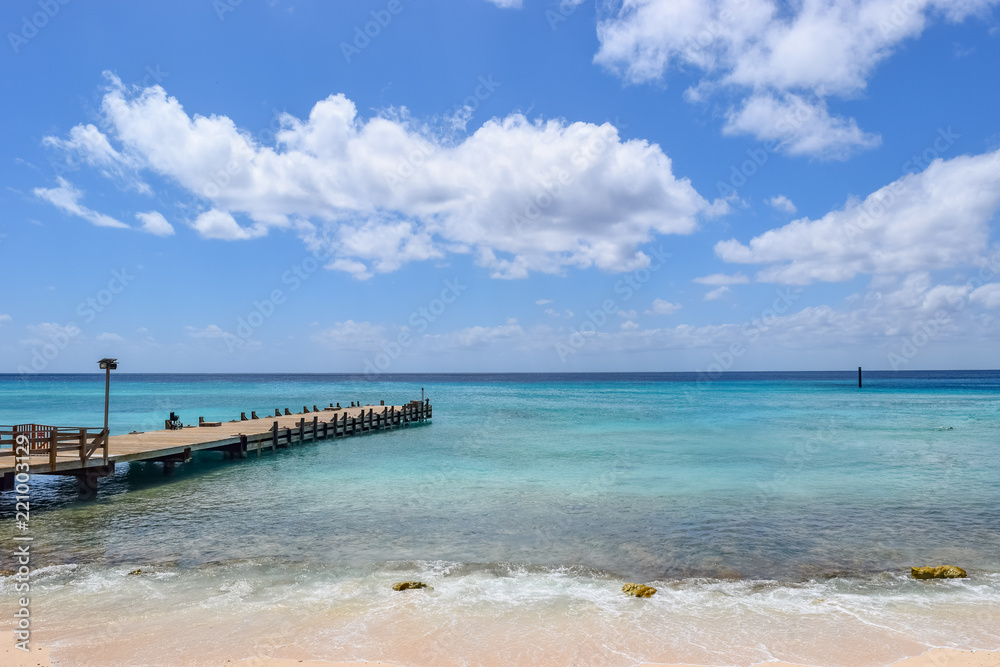 Jetty/Boardwalk leading into the ocean from a tropical beach in the Caribbean