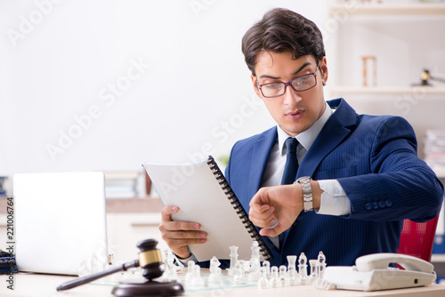 Young lawyer playing chess to train his court strategy and tacti photo