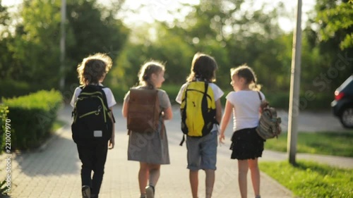 Four Students Are Talking and Walking In School Uniforms.