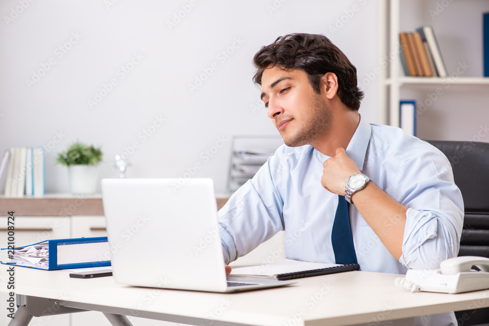 Young handsome businessman working in office Young handsome businessman working in office