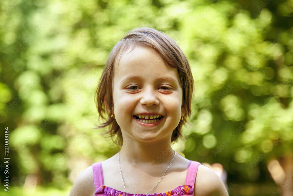 Smile of little girl as the biggest indicator of a children's happiness. Beautiful child sincerely smiling and laughing. Freedom to express emotions, happy childhood joy concept. Smile of little girl as the biggest indicator of a children's happiness. Beautiful child sincerely smiling and laughing. Freedom to express emotions, happy childhood joy concept.
