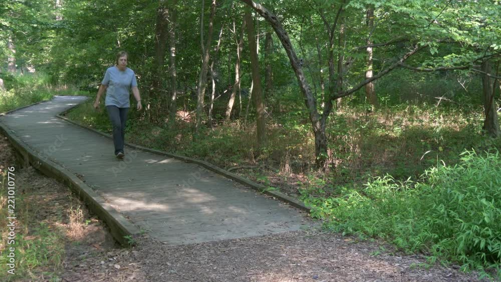 Woman mysteriously appears on a hiking trail in the woods 4K Woman mysteriously appears on a hiking trail in the woods 4K