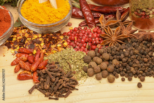 Various spices on wooden background. © brszattila