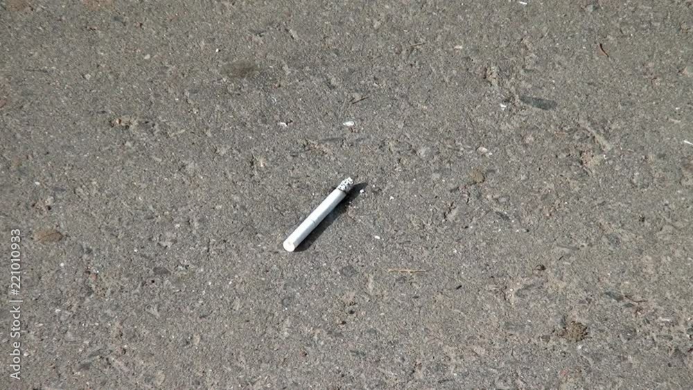 Cigarette smoke on the pavement. Tobacco environmental pollution. Cigarette smoke on the pavement. Tobacco environmental pollution.