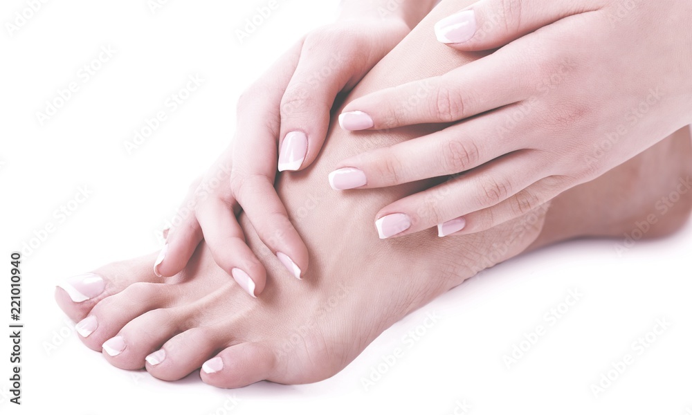 Perfect hands on female feet isolated on white background Perfect hands on female feet isolated on white background