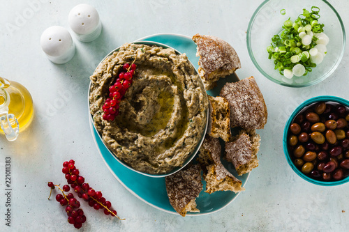 Appetizer with baba ganush of eggplant, olives from kalamata, green onions and fresh rye bread. Mediterranean snack. Vegan healthy food photo