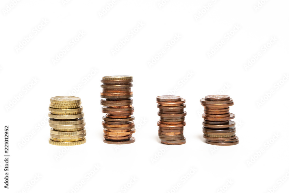 some stacked euro coins on a white surface some stacked euro coins on a white surface