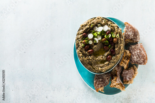 Appetizer with baba ganush of eggplant, olives from kalamata, green onions and fresh rye bread. Mediterranean snack. Vegan healthy food photo
