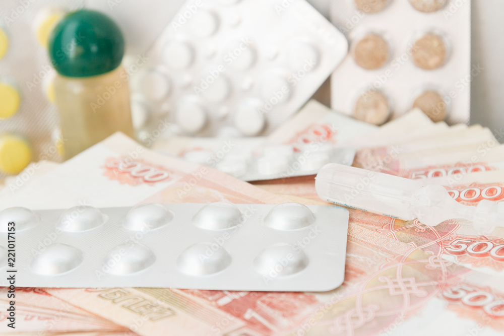 Pills and drugs with large Russian money lie on the table