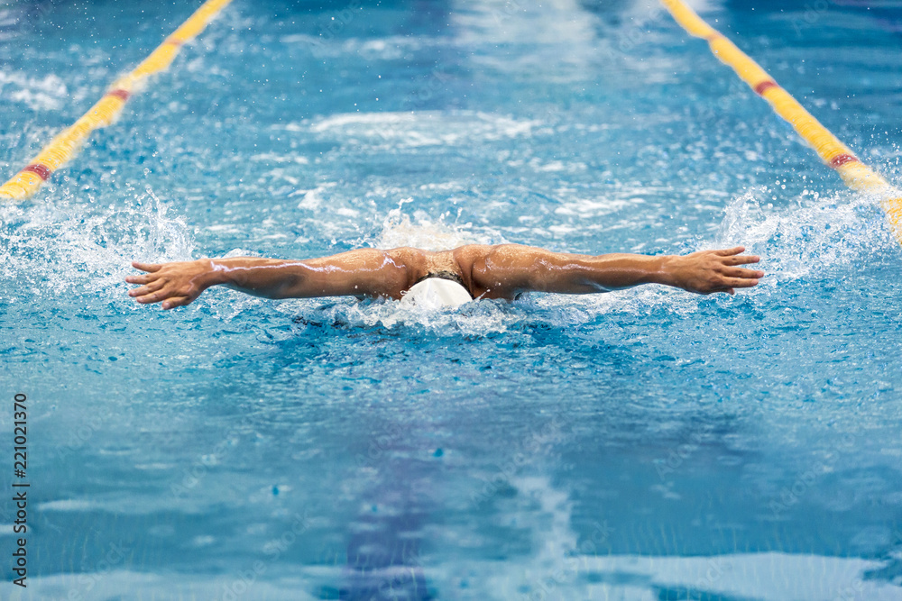 Young athletic man swimming