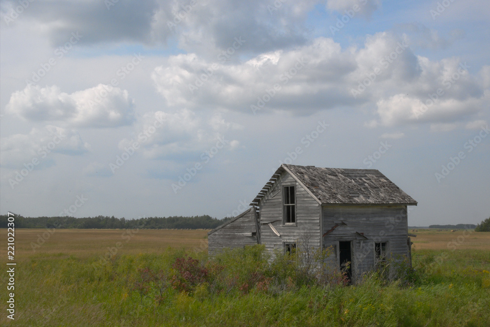 Abandoned Farm House with clouds in the Minnesota Prairie