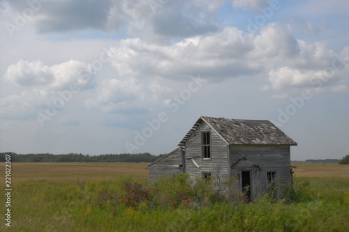 Abandoned Farm House with clouds in the Minnesota Prairie
