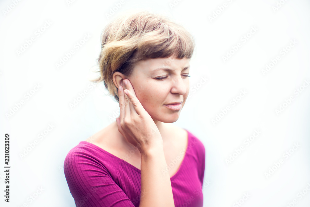 Tinnitus. Closeup up side profile sick female having ear pain touching her painful head isolated on white background Tinnitus. Closeup up side profile sick female having ear pain touching her painful head isolated on white background
