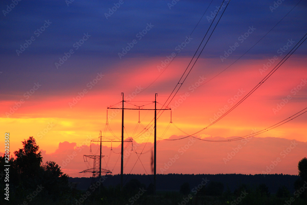 Sunset with crimson clouds and high-voltage line