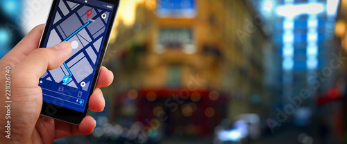 Close up of Tourist using GPS map navigation on smartphone application screen for direction to destination address in the city with travel and technology concept. photo