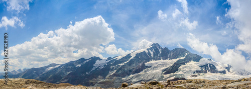 Wide view of the Grossglockner Mountain range with parallel clouds movement, showing the largest peak of Austria in all its glory