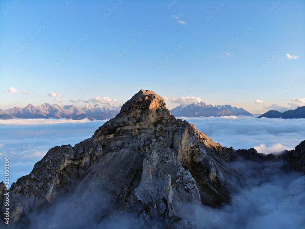 Mountain peaks of the Caucasus towering above the clouds. Fog in the mountain gorge.
