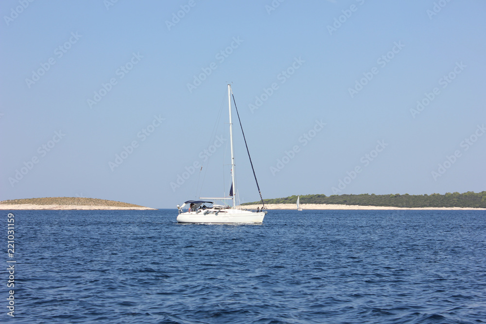 Sail boat on blue water