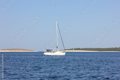 Sail boat on blue water