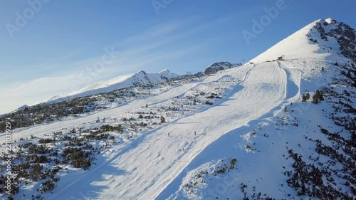 Aerial view of skiers on ski slope on Strbske Pleso resort in High Tatras mountains, Slovakia.
