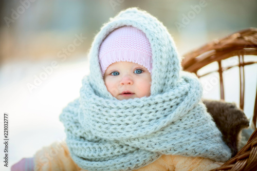 Winter portrait of little girl in fur coat