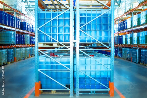Plastic Barrels. Warehouse of chemical products. Stelazhy with barrels. Chemistry. Manufacture of chemicals. Pallets with barrels. Storage of chemicals.