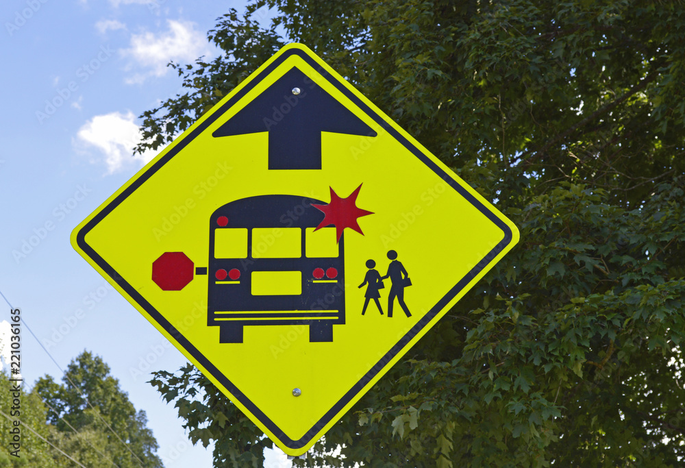 Warning sign informing drivers that there is a school bus stop ahead