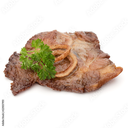 Cooked fried pork meat with parsley herb leaves and onion slices garnish isolated on white background cutout