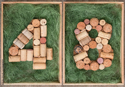 Number 48  forty eight  made of wine corks on green background in wooden box