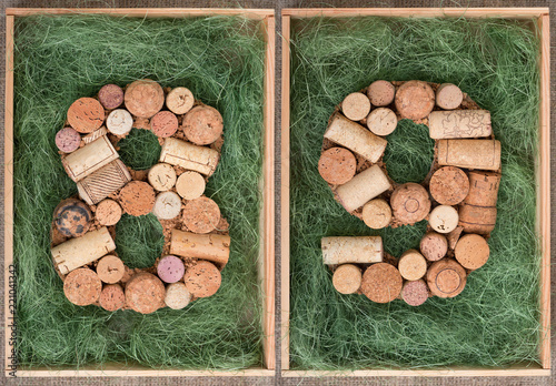 Number 89  eighty nine made of wine corks on green background in wooden box photo