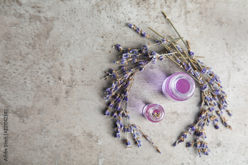 Fototapeta Naklejka Na Ścianę i Meble -  Natural herbal oil in glass bottles and lavender flowers on color background, top view. Space for text