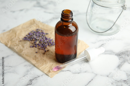 Fototapeta Naklejka Na Ścianę i Meble -  Natural herbal oil and lavender on marble table