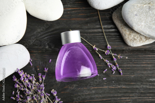 Fototapeta Naklejka Na Ścianę i Meble -  Flat lay composition with natural herbal oil and lavender flowers on wooden background