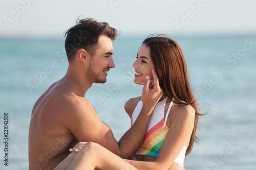 Happy young couple at beach on sunny day © New Africa