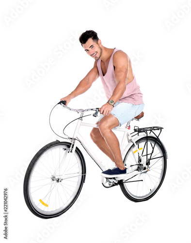 Handsome young hipster man riding bicycle on white background