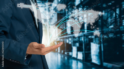 Bild auf Leinwand World map on hand businessman with Modern Trade warehouse logistics, uncle plans to invest in transport, from domestic to global