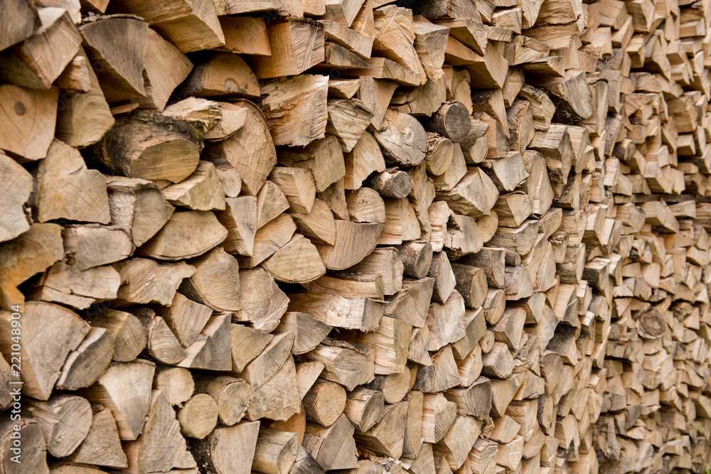 Background of stacked, dry chopped logs used for firewood. Background of stacked, dry chopped logs used for firewood.
