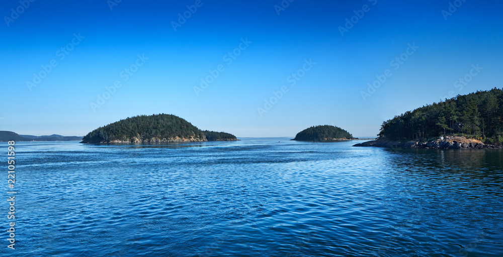 A few of over 100 San Juan Islands on a sunny summer afternoon in Washington A few of over 100 San Juan Islands on a sunny summer afternoon in Washington