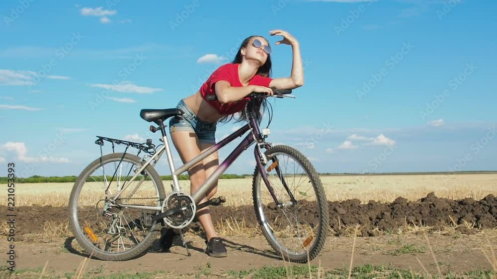 Beautiful girl posing with bicycle. A model with a bicycle. Beautiful girl posing with bicycle. A model with a bicycle.