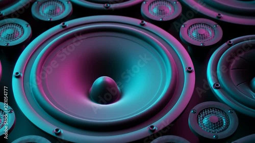 Playing speaker membranes stacked in endless loop. Lit by colourful retro lights