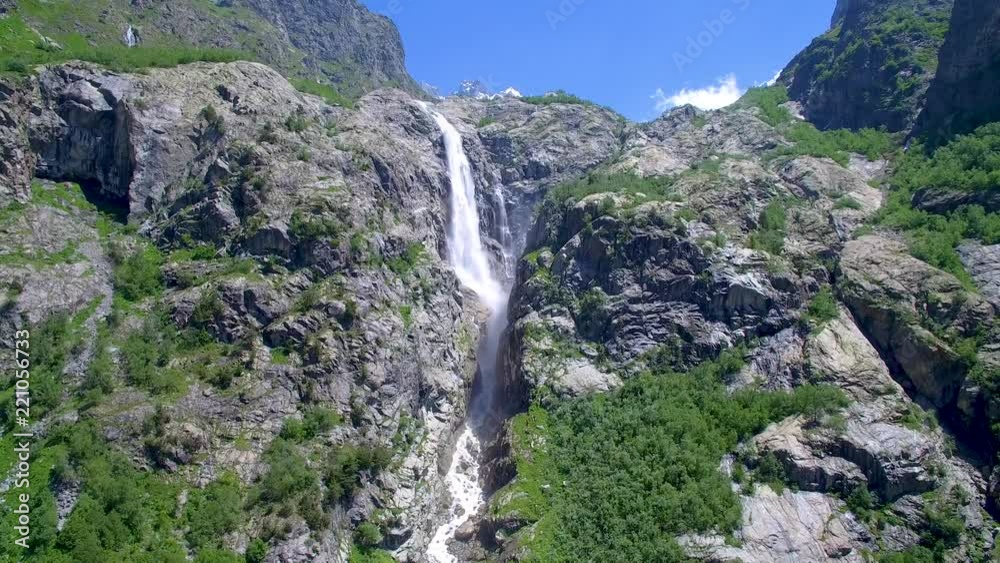 waterfall and peak of mountain with snow aerial view waterfall and peak of mountain with snow aerial view