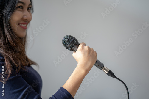 Speaker at conference holding microphone in the hand in thailand