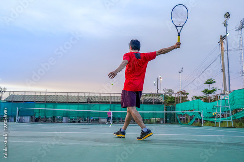 Tennis players playing a match on the court on a sunny day