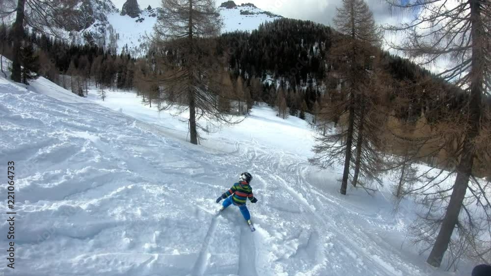 Freeride skiing. Little boy skiing in the wild. A 5 year old child enjoys a winter holiday in the Alpine resort. Stabilized shot. Slow motion. Freeride skiing. Little boy skiing in the wild. A 5 year old child enjoys a winter holiday in the Alpine resort. Stabilized shot. Slow motion.