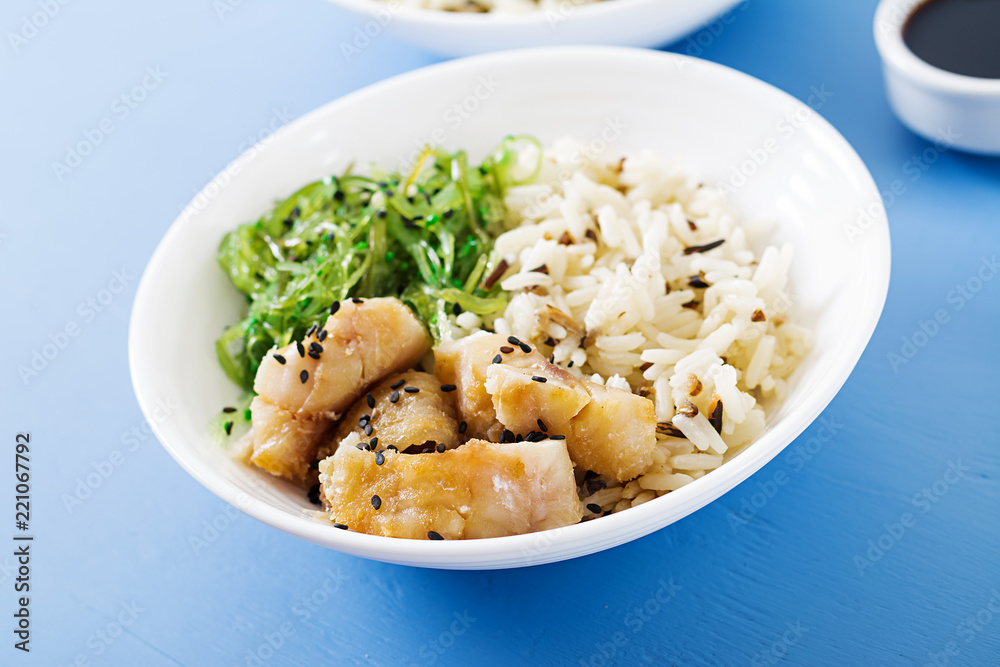 Japanese food. Bowl of rice, boiled white fish and wakame chuka or seaweed salad. Japanese food. Bowl of rice, boiled white fish and wakame chuka or seaweed salad.