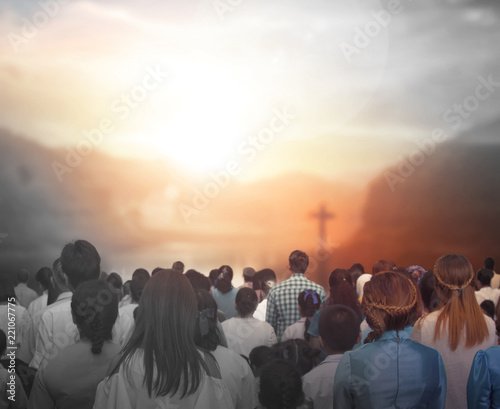 Praise and worship concept:Silhouette of Christian prayers raising hand while praying to the Jesus photo