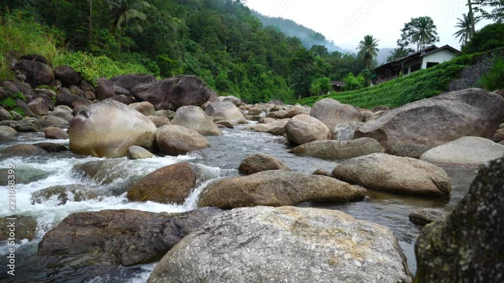 Nature water flow from mountain pass many rock to the river in the country small village.Sound of waterfall fell relax calm and peaceful. Nature water flow from mountain pass many rock to the river in the country small village.Sound of waterfall fell relax calm and peaceful.
